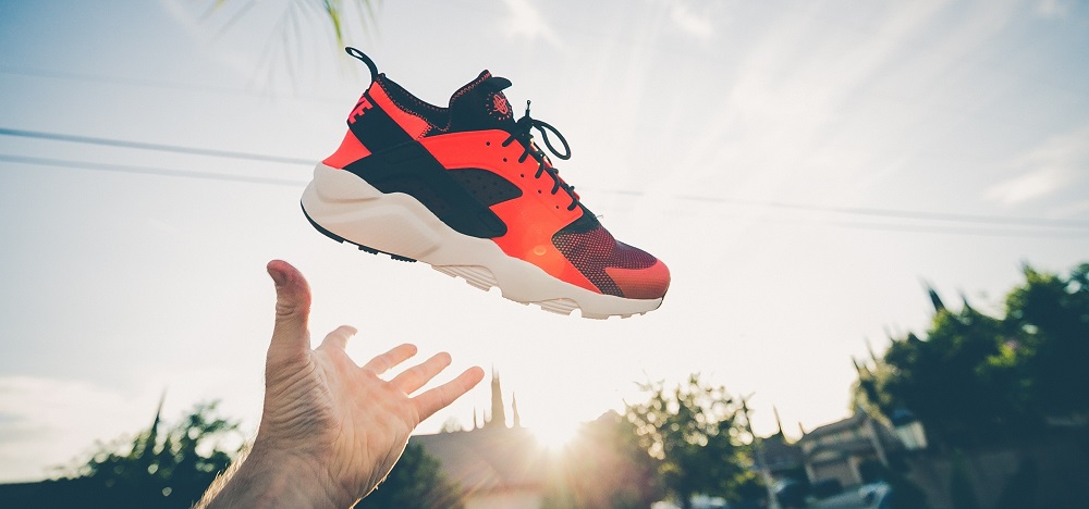 Photo by Jakob Owens on Unsplash Photo of a tennis shoe lifted triumphantly into the air