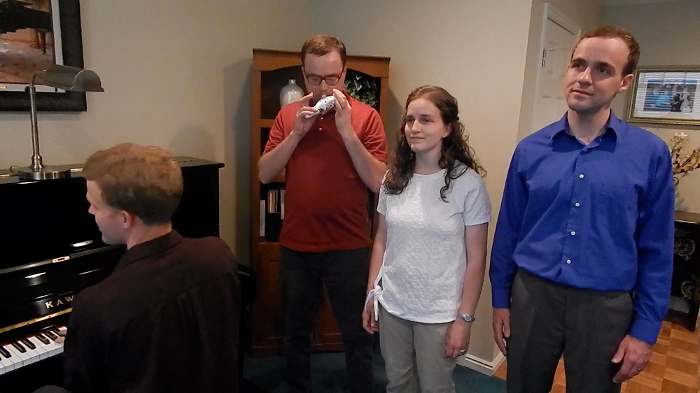 Photo of Tyler, CJ, Audrey, and Jeremy performing a musical number